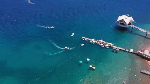 Aerial Footage over Deck Marina With Speed boats and blue sea