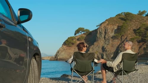 Couple Enjoying Romantic Getaway on Beach Near Car