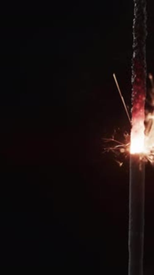 Sparkling Sparkler Emitting Glowing Sparks in Dark