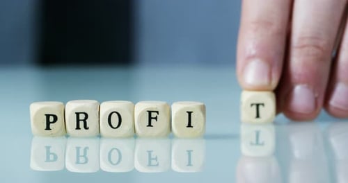 Slow motion macro of the word "Profit" of the wooden letter blocks . Concept of financial market a