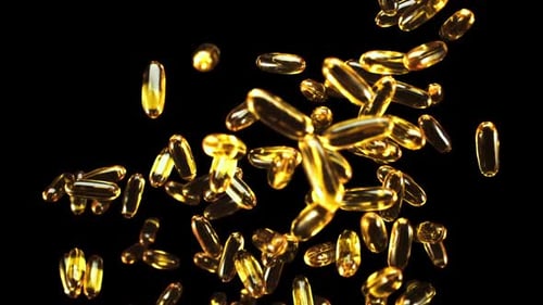 Floating Golden Capsules on Black Background