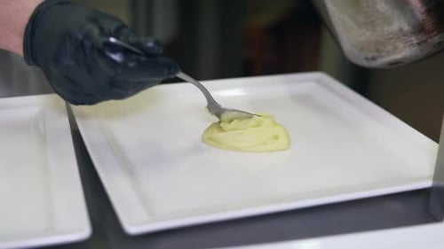 Chef Plates Mashed Potatoes with Precision in Kitchen