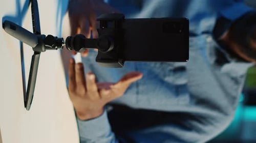 Vertical Video Phone on Holder Used By Content Creator