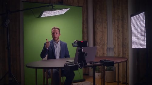 Engaging in a Professional Video Shoot in a Studio Featuring a Green Screen Background