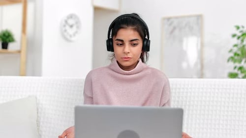 Young Woman Working from Home on Laptop