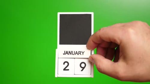 Hand Adjusting January 29 Calendar on Green Screen