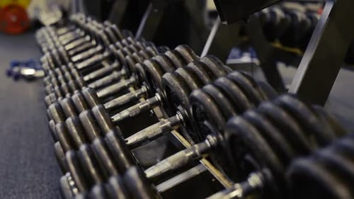 Hands Of Senior Couple In Gym Working Out With Weights