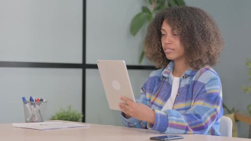 Happy Woman Using Tablet at Desk