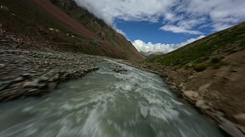 FPV Drone Flies Over a Mountain River in Tibet