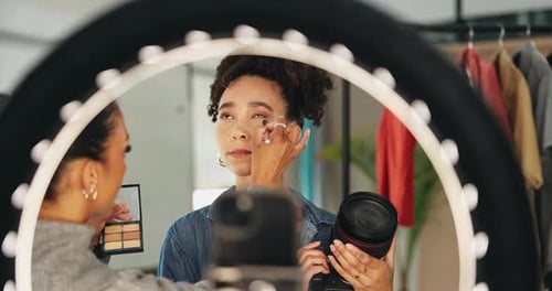 Young Adult Applying Makeup for Online Video