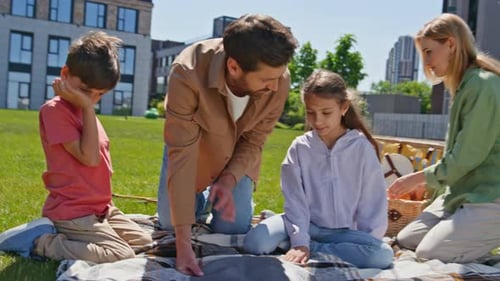 Friendly Family Enjoy Picnic on Green Grass Near Apartment Parents Kids Resting