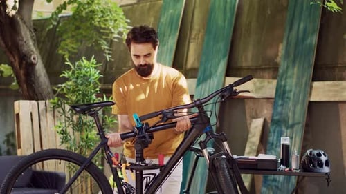 Man Fixing Bike in Backyard on Sunny Day