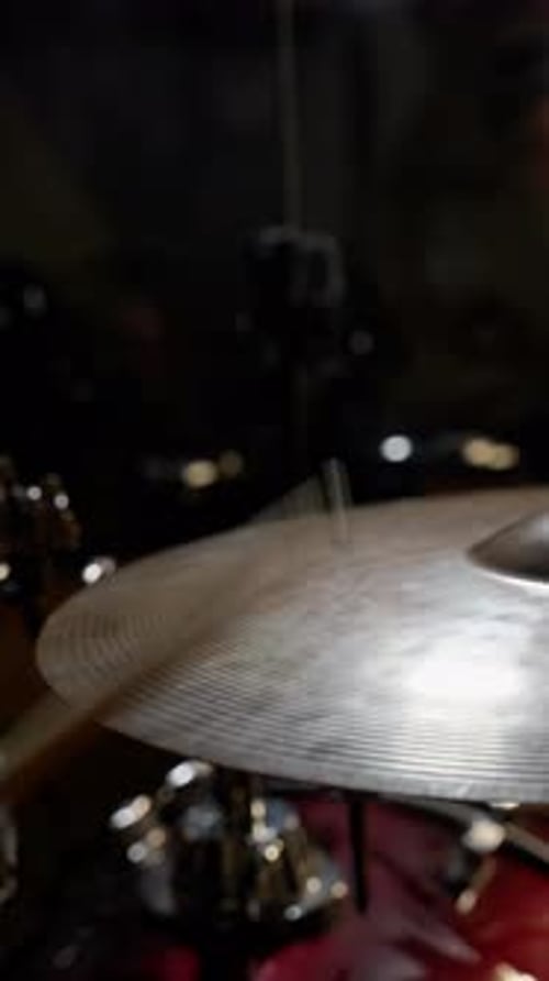 Drum Sticks Hitting Cymbal at Night Performance