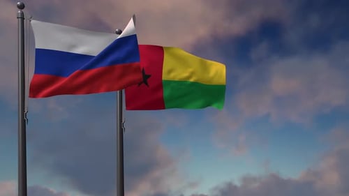 Flags of Russia and Guinea-Bissau Waving Against Cloudy Sky
