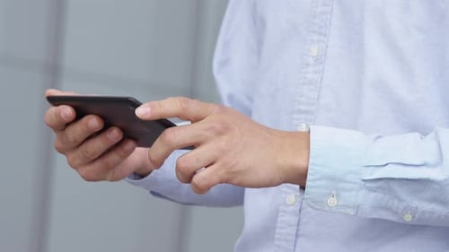 Man Using Tablet Device Outdoors in Urban Setting