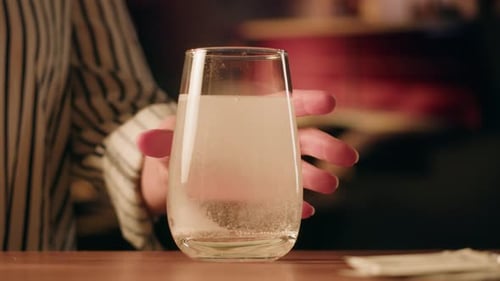 Hand Taking Effervescent Tablet Glass of Water