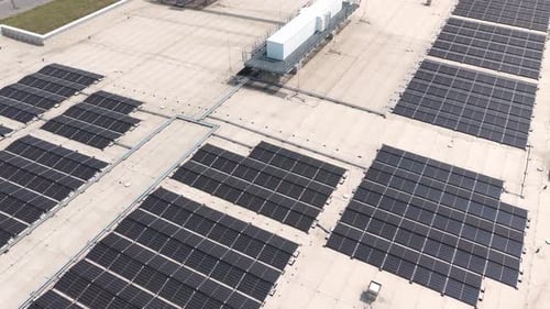 Solar panels covering large building rooftop generating clean energy