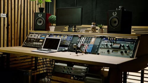 A recording studio control panel mixer with an equalizer faders buttons for broadcasting a recording