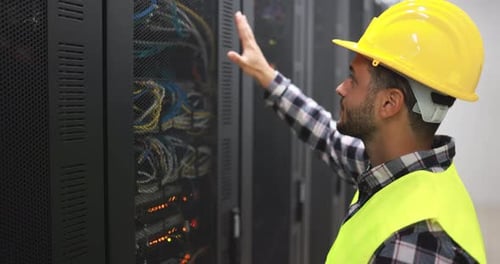 Young Man Working for Inspection Inside Server Data Network Center Administrator