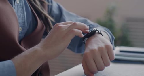 Closeup of Male Hand Using Smart Watch Touching Screen Focused on Online Communication in Office