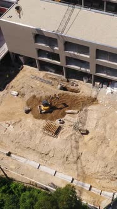 Construction Site with Excavator and Crane Aerial View