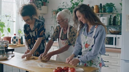 Three People Preparing Food Together in a Kitchen