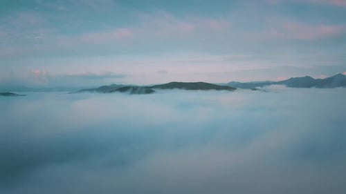 Heavenly ASMR view of endless clouds below the beautiful mountains peaks.