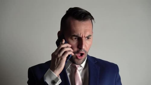 Furious Man Yelling Into Cell Phone