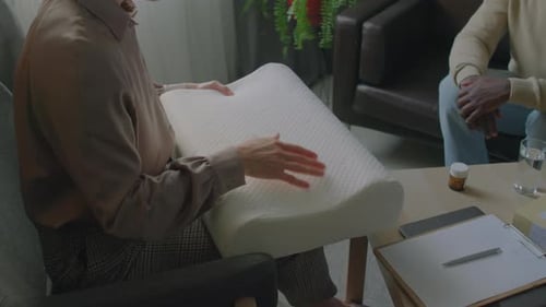 Physical Therapist Demonstrating Orthopedic Pillow for Patient