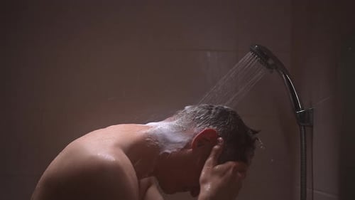 Man Washing Hair Under Shower in Bathroom
