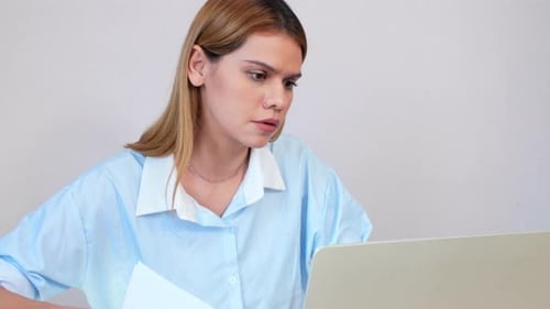 Woman Works at Laptop in Bright Office