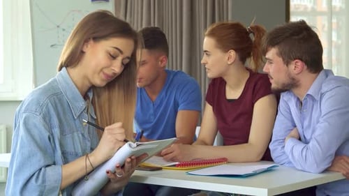 Young Adults Collaborating Around Table