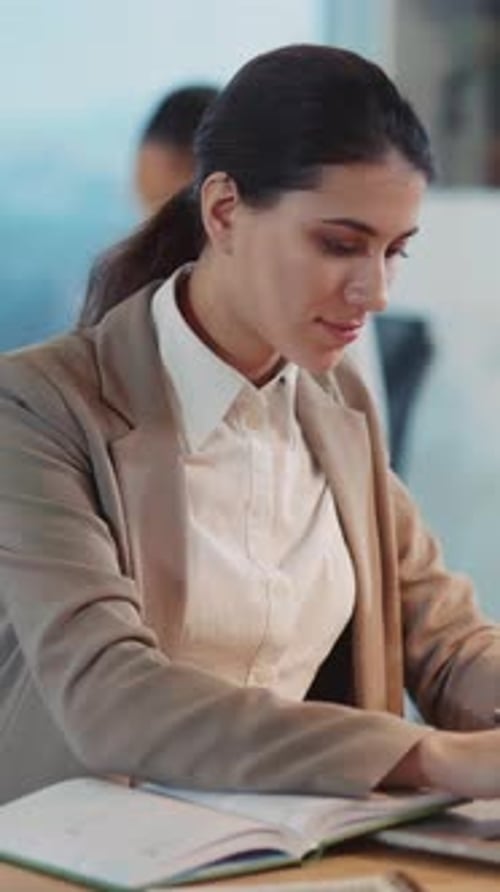 Young Caucasian Woman Working on Laptop Computer in Creative Multiethnic Corporate Office Business