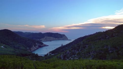 Ibiza Cala Benirras bay and coastline at sunset. Great aerial view flight drone