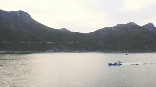 4k drone footage of a boat travelling across the sea