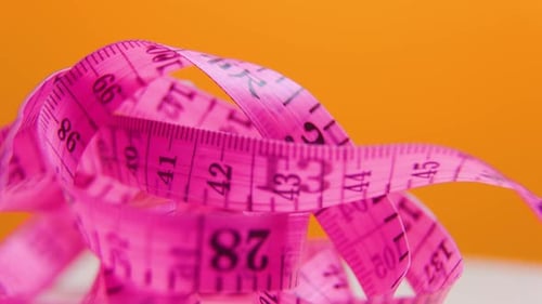 Precision in Rotation CloseUp View of Measuring Tape in Action Flex Meter Unveiling Metrics