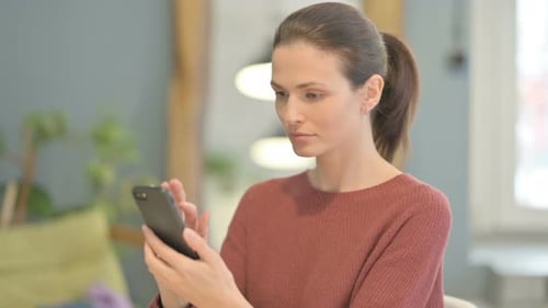 Woman Using Smartphone Indoors in Close Up