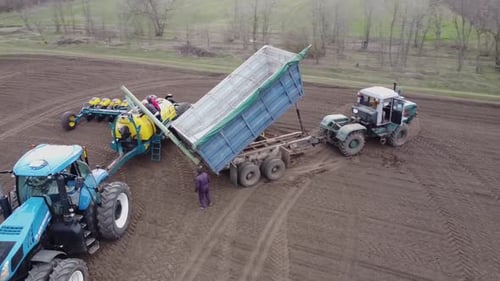 Blue tractor OA working on the field in Ukraine
