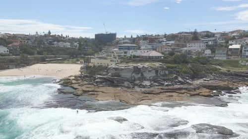 Dangerous Waves Over Rocky Shore With Surfers At Tamarama Point Headland In Eastern Suburbs, Sydney,