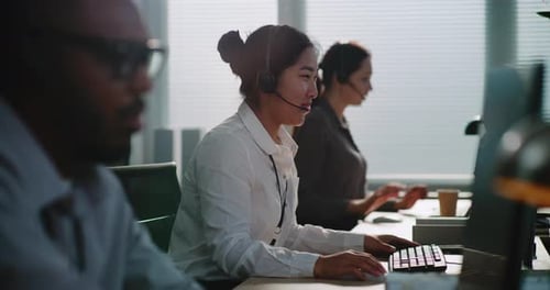 Call Center Office Multiethnic Team of Hotline Operators in Headsets Working