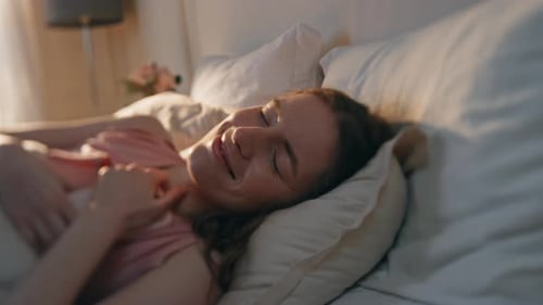 Woman Relaxing in Bed in the Morning