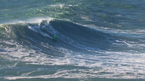 Aerial View of a Big Wave Surfer on a Big Wave in Nazare Surfing Spot Portugal