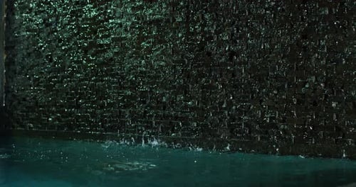 Water Running Down Dark Brick Wall