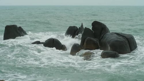 Powerful Waves on Rocky Cliff Beach