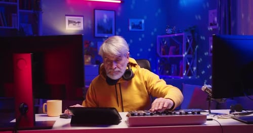 Portrait of Caucasian Old Male Professional DJ Works in House in Neon Lights Music Creator Streaming