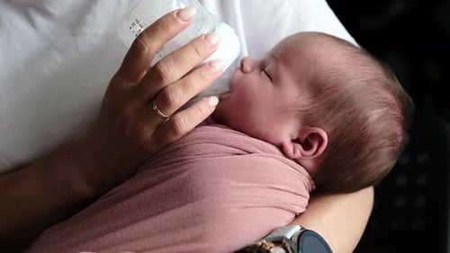 Baby Being Bottle-Fed in a Home