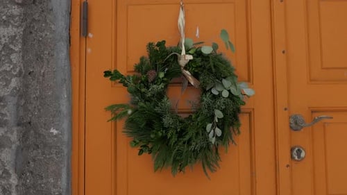 Festive Christmas Wreath on Orange Door