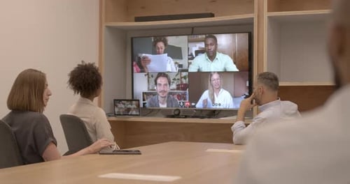 Corporate office workers on a video call with coworkers working from home remotely