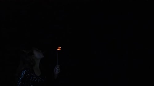 Woman Performance Fire Breathing in the Dark Night