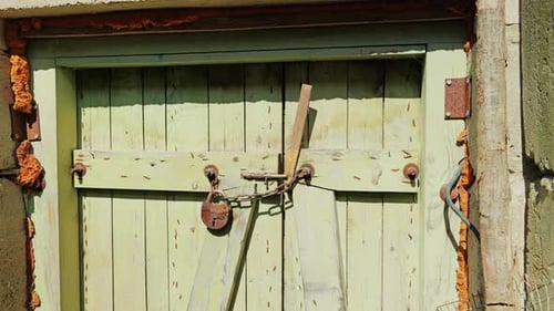 Old Soviet-Era Lock Secures Weathered Wooden Door With Chain – Rustic Security